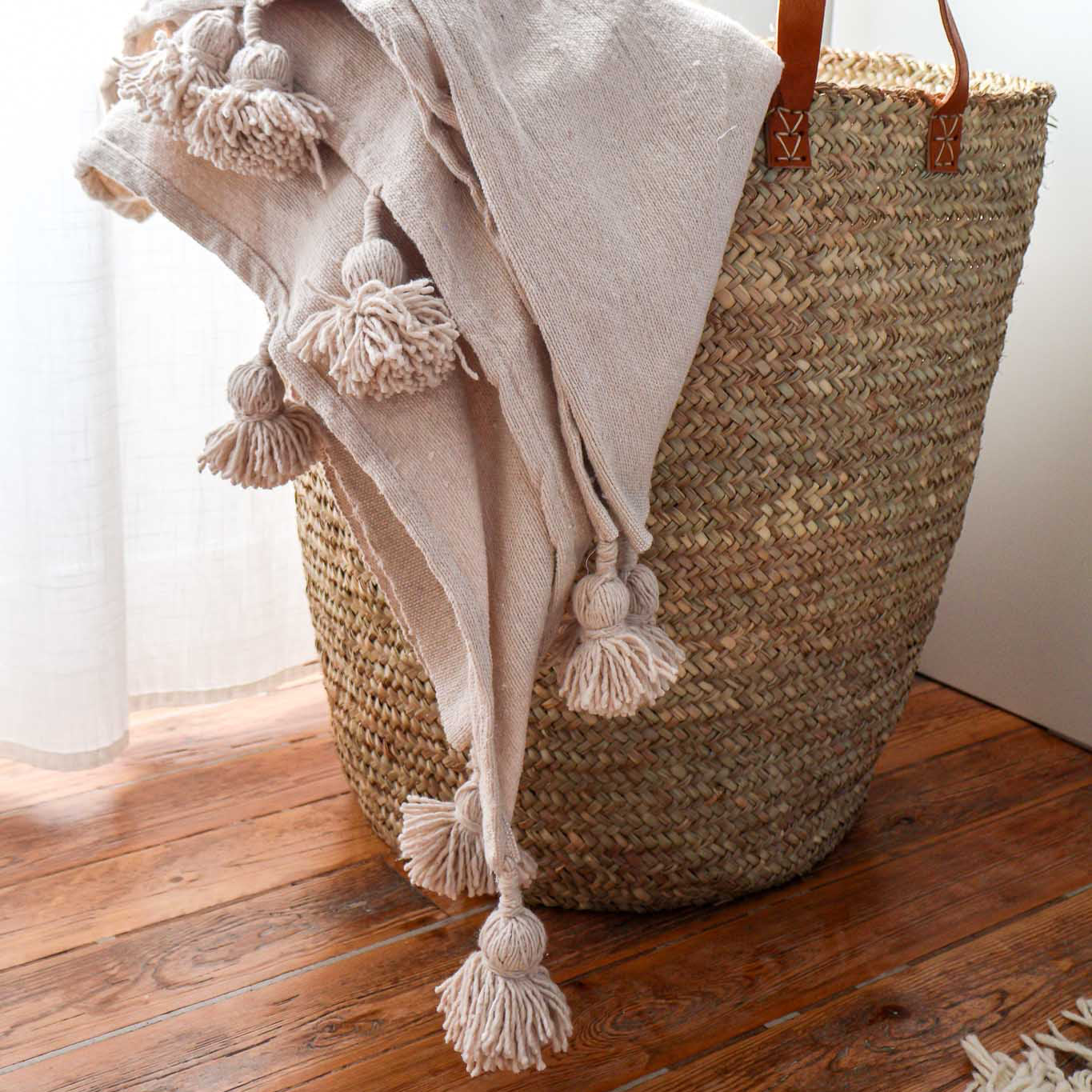 Plaid en coton tissé à pompons